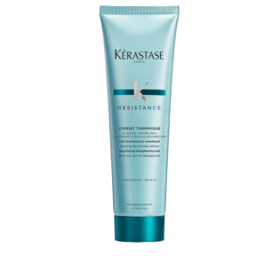 A turquoise tube of Kérastase Resistance Ciment Thermique blow-dry care for damaged hair, labeled as a strengthening heat protectant, 150 ml size. This essential Resistance Ciment Thermique formula helps fortify and protect hair from heat styling while promoting a healthier, more resilient finish. | Blush Salon Collective - Fargo, ND