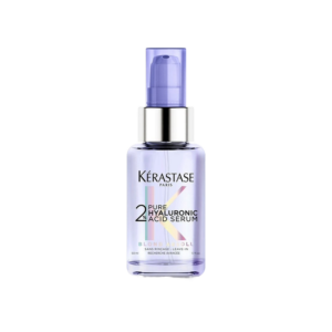 A clear bottle of Kérastase Paris Blond Absolu 2% Pure Hyaluronic Acid Serum with a purple pump cap, shown on a plain light background. | Blush Salon Collective - Fargo, ND