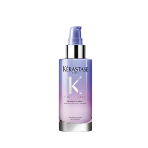 A pump bottle of Kérastase Blond Absolu Cicaplasme hair serum with a gradient purple and pink design, shown against a white background. | Blush Salon Collective - Fargo, ND