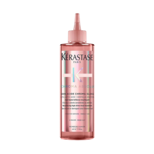 A pink bottle of Kérastase Chroma Absolu Soin Acide Chroma Gloss hair treatment, featuring a pointed applicator tip, is shown against a white background. | Blush Salon Collective - Fargo, ND