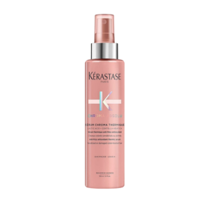 A pink bottle of Kérastase Paris Chroma Absolu Serum Chroma Thermique, a nourishing hair serum with a spray nozzle, designed as a heat-protecting leave-in treatment for sensitized or damaged color-treated hair. | Blush Salon Collective - Fargo, ND