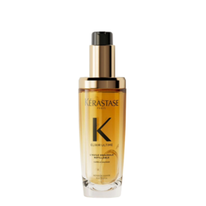 A bottle of Kérastase Elixir Ultime hair oil with a gold cap and black pump dispenser, filled with amber liquid, on a plain white background—perfect for showcasing the nourishing benefits of Elixr Ultime Oil. | Blush Salon Collective - Fargo, ND
