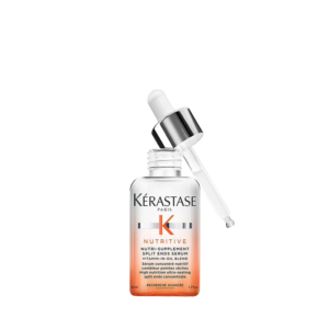 A bottle of Kérastase Nutritive Nutri-Supplement Split End Serum with a dropper, containing a vitamin-in-oil blend for hair care, against a white background. This nourishing hair serum is designed to target and repair split ends, leaving your hair looking healthy and smooth. | Blush Salon Collective - Fargo, ND