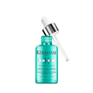 A turquoise bottle of Kérastase Resistance Extentioniste scalp and hair strengthening serum with a silver dropper resting beside the open bottle on a white background. | Blush Salon Collective - Fargo, ND