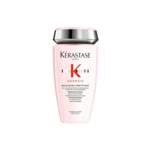 A bottle of Kérastase Genesis Bain Nutri-Fortifiant shampoo for weakened hair, with a pink body, silver and black cap, and Genesis shampoo product details printed on the front. | Blush Salon Collective - Fargo, ND