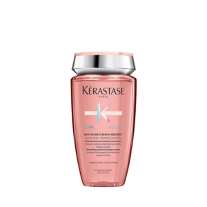 A pink bottle of Kérastase Paris Chroma Absolu Bain Riche shampoo with a silver cap, featuring product details in white and pink text on the front. | Blush Salon Collective - Fargo, ND