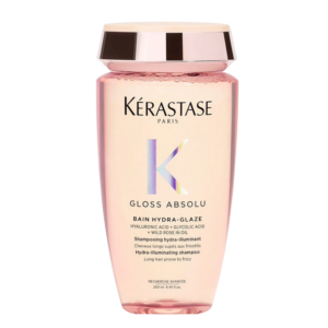 A bottle of Kérastase Gloss Absolu Bain Hydra-Glaze shampoo with wild rose oil, hyaluronic acid, and glycolic acid, designed for long hair prone to frizz and seeking a radiant hair gloss. | Blush Salon Collective - Fargo, ND