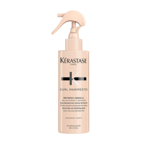 A beige spray bottle of Kérastase Curl Manifesto Refresh Absolu for curly hair, displaying product name and details on the front label—an essential addition to any curl care routine. | Blush Salon Collective - Fargo, ND