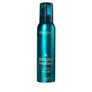 A teal bottle of Kérastase Paris Bouffante Styling Mousse strong hold hair mousse with gold and white text on the label, against a light gray background. | Blush Salon Collective - Fargo, ND