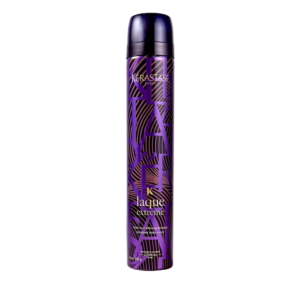 A tall, cylindrical can of Kérastase Laque Extreme hair spray, designed for ultimate styling hold, features a striking purple and black geometric pattern and stands upright against a plain white background. | Blush Salon Collective - Fargo, ND