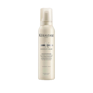 A bottle of Kérastase Densifique Densimorphose hair mousse designed to boost hair density, set against a white background. The off-white bottle features black and silver text along with a clear cap. | Blush Salon Collective - Fargo, ND