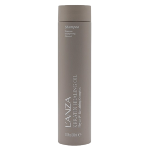 A beige bottle of L’ANZA Keratin Healing Oil Shampoo with a matte finish, standing upright against a plain white background, showcases this luxurious healing shampoo enriched with keratin for stronger, nourished hair. | Blush Salon Collective - Fargo, ND
