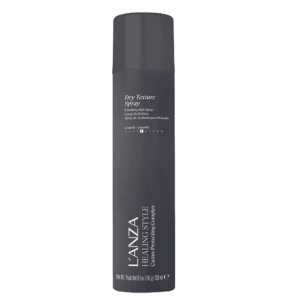A tall black can of L’ANZA Healing Style Dry Texture Spray stands out with white and silver text on a plain white background, showcasing its premium dry texture spray formula for effortless styling. | Blush Salon Collective - Fargo, ND