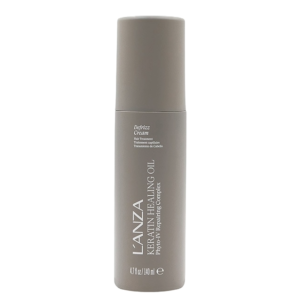 A grey bottle of L’ANZA Keratin Healing Oil Defrizz Cream stands upright against a white background, highlighting its powerful hair smoothing and anti-frizz benefits. | Blush Salon Collective - Fargo, ND